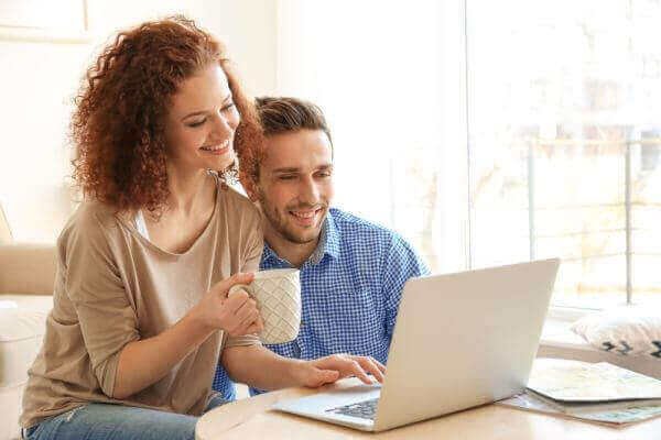 Couple using laptop together