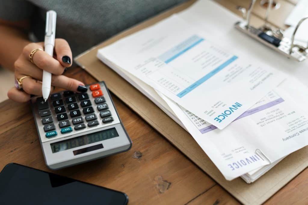 woman with calculator and invoices